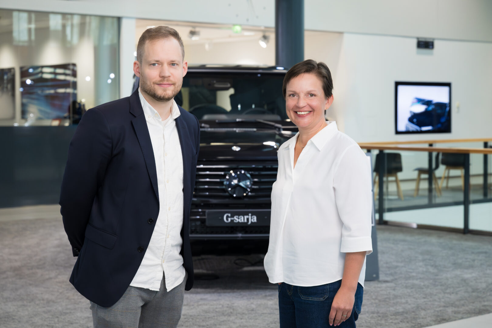 Veho’s Head of Real Estate Management Niko Karjalainen and Head of Sustainability Lia Samuelsson at a Veho showroom property, with a G-Class Mercedes in the background.